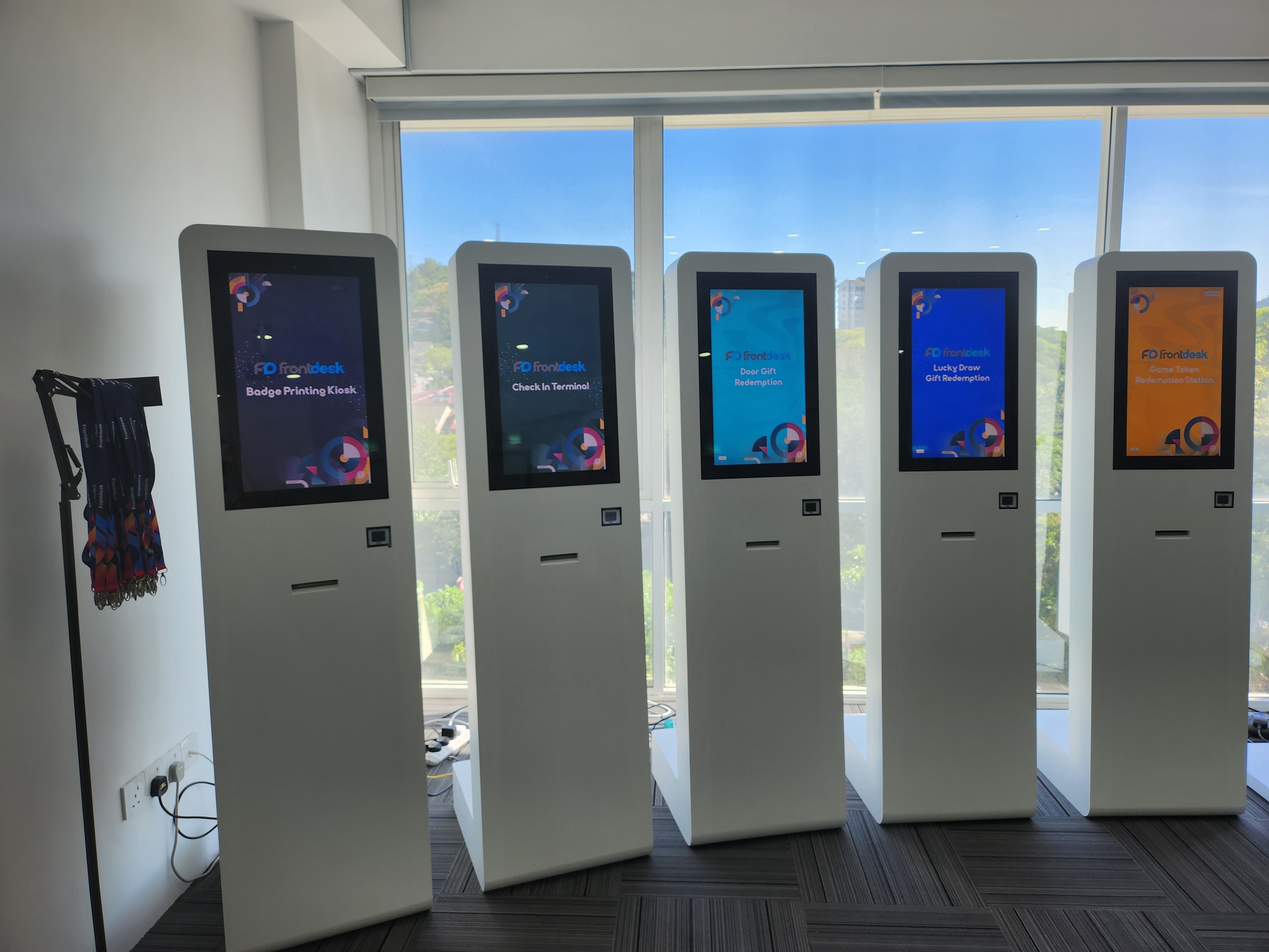 The image shows a kiosk, a self-service interactive terminal with a touch screen display. Users can access services, make payments, and obtain information independently.